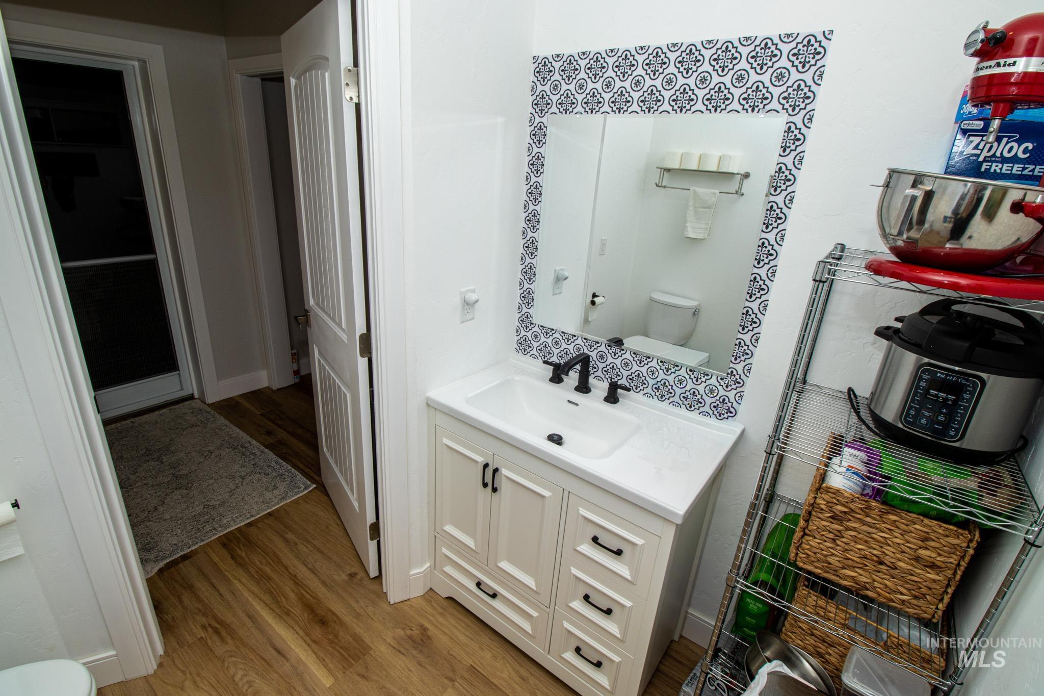 5404 Freeman Creek Road Lenore, ID 83541 - Photo 18 of 50 Half bathroom with vanity and light wood finished floors