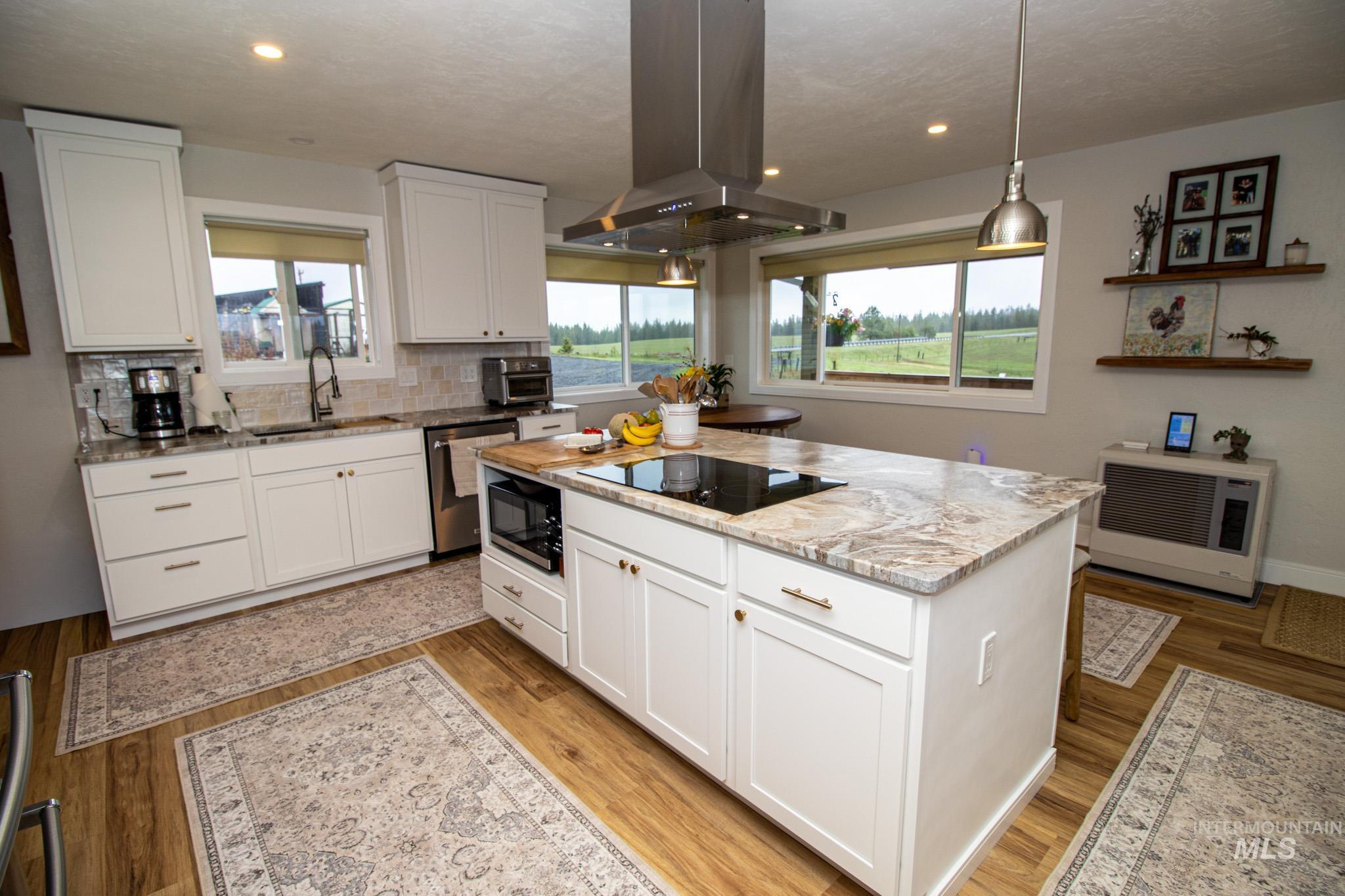 5404 Freeman Creek Road Lenore, ID 83541 - Photo 19 of 50 Kitchen featuring white cabinetry, island range hood, and light stone counters