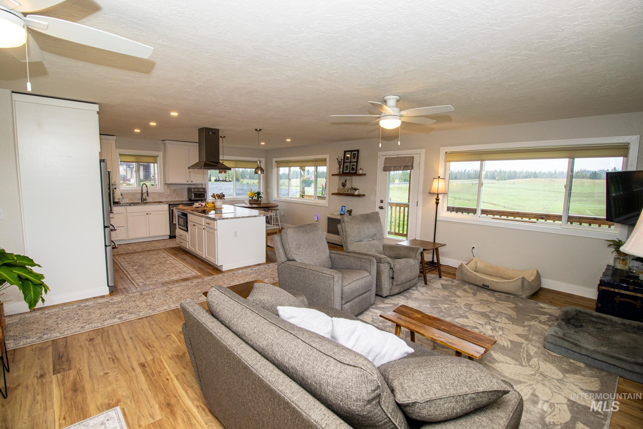 5404 Freeman Creek Road Lenore, ID 83541 - Photo 26 of 50 Living room with a ceiling fan and light wood-type flooring
