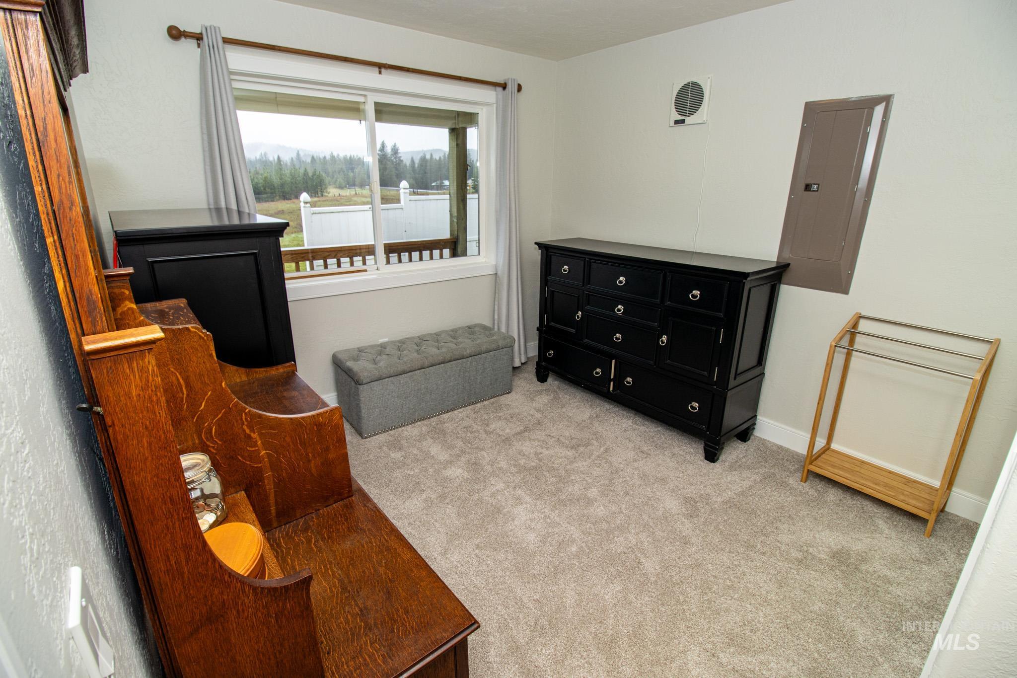 5404 Freeman Creek Road Lenore, ID 83541 - Photo 33 of 50 Living area with light colored carpet and electric panel