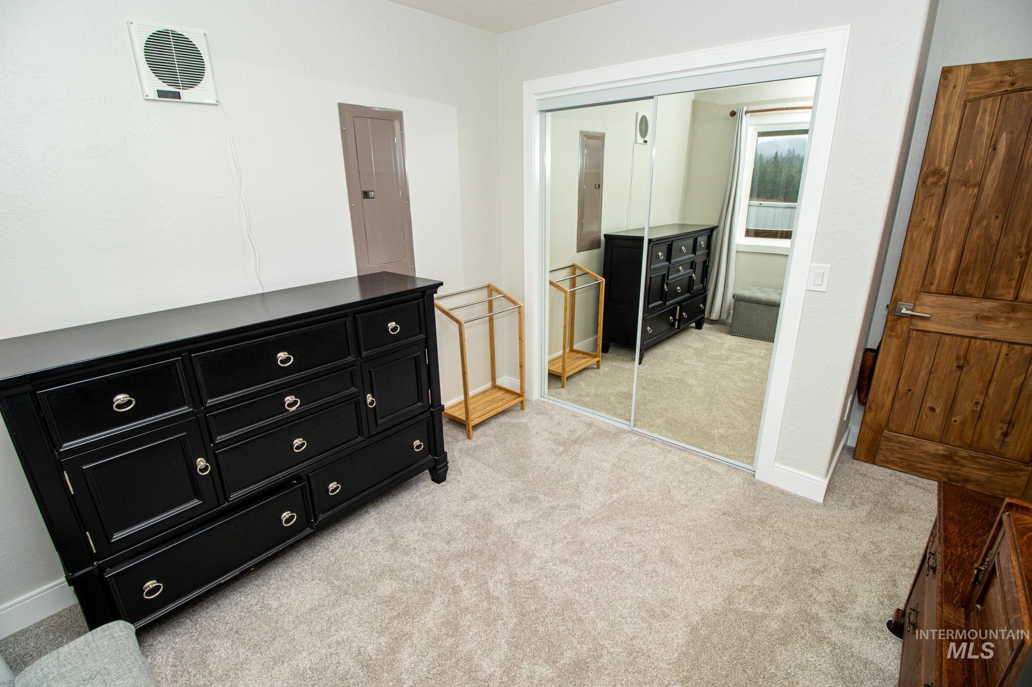 5404 Freeman Creek Road Lenore, ID 83541 - Photo 34 of 50 Bedroom featuring light carpet, a closet, and electric panel