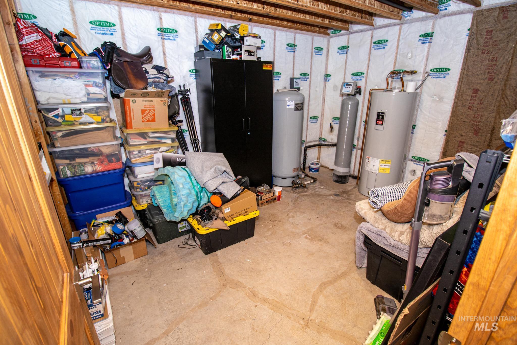 5404 Freeman Creek Road Lenore, ID 83541 - Photo 38 of 50 Basement with electric water heater, a water softener, and a water pressure tank