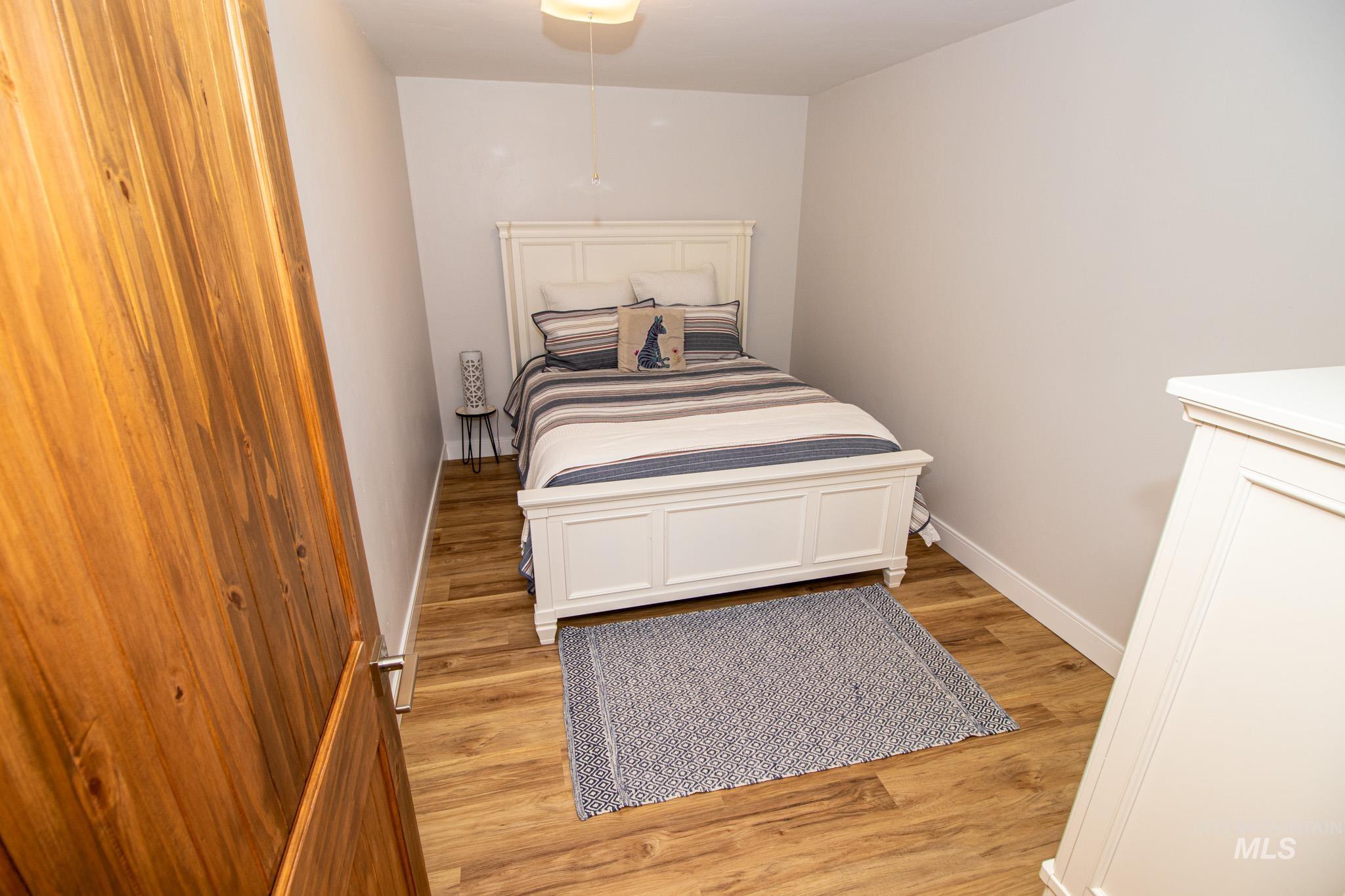 5404 Freeman Creek Road Lenore, ID 83541 - Photo 43 of 50 Bedroom featuring light wood finished floors and baseboards