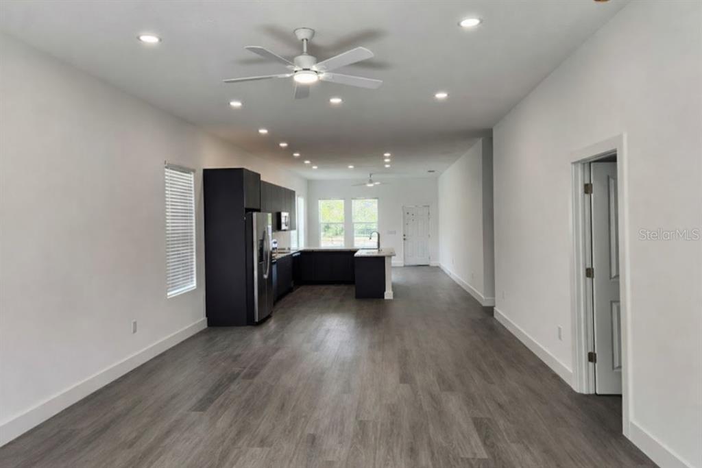 9211 Northcliffe Boulevard Spring Hill, FL 34606 - Photo 11 of 30 a view of a kitchen with a sink and wooden floor