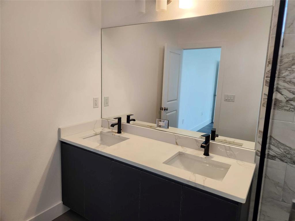 9211 Northcliffe Boulevard Spring Hill, FL 34606 - Photo 18 of 30 a bathroom with a sink and a mirror