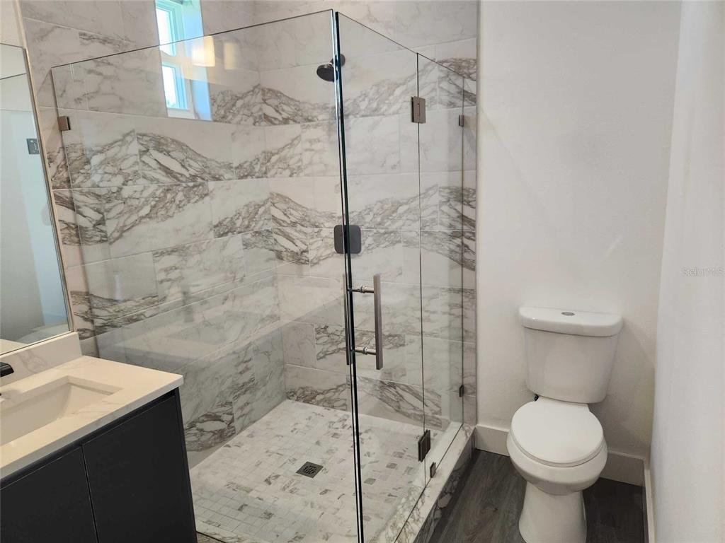 9211 Northcliffe Boulevard Spring Hill, FL 34606 - Photo 19 of 30 a bathroom with a sink toilet and shower