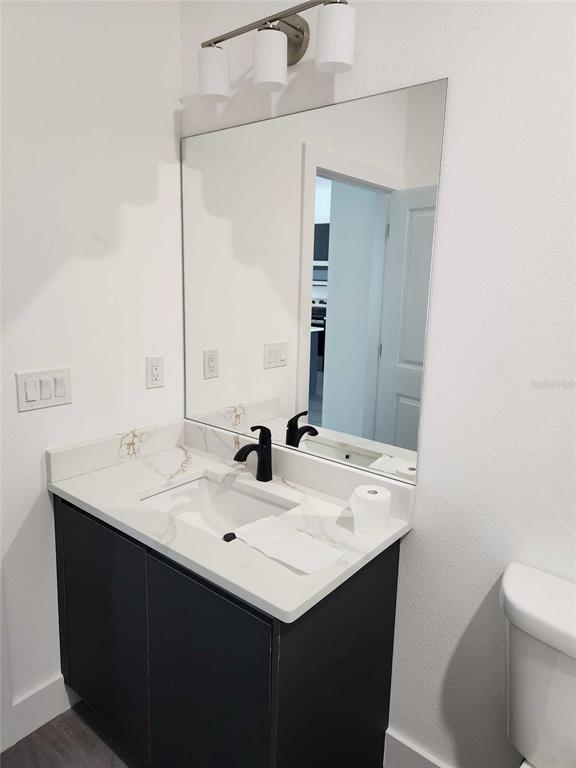 9211 Northcliffe Boulevard Spring Hill, FL 34606 - Photo 22 of 30 a bathroom with a sink and a mirror