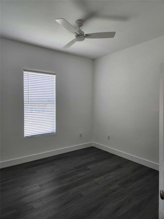 9211 Northcliffe Boulevard Spring Hill, FL 34606 - Photo 24 of 30 an empty room with wooden floor and windows