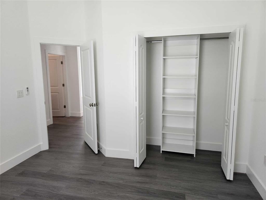 9211 Northcliffe Boulevard Spring Hill, FL 34606 - Photo 26 of 30 a view of walk in closet with empty racks