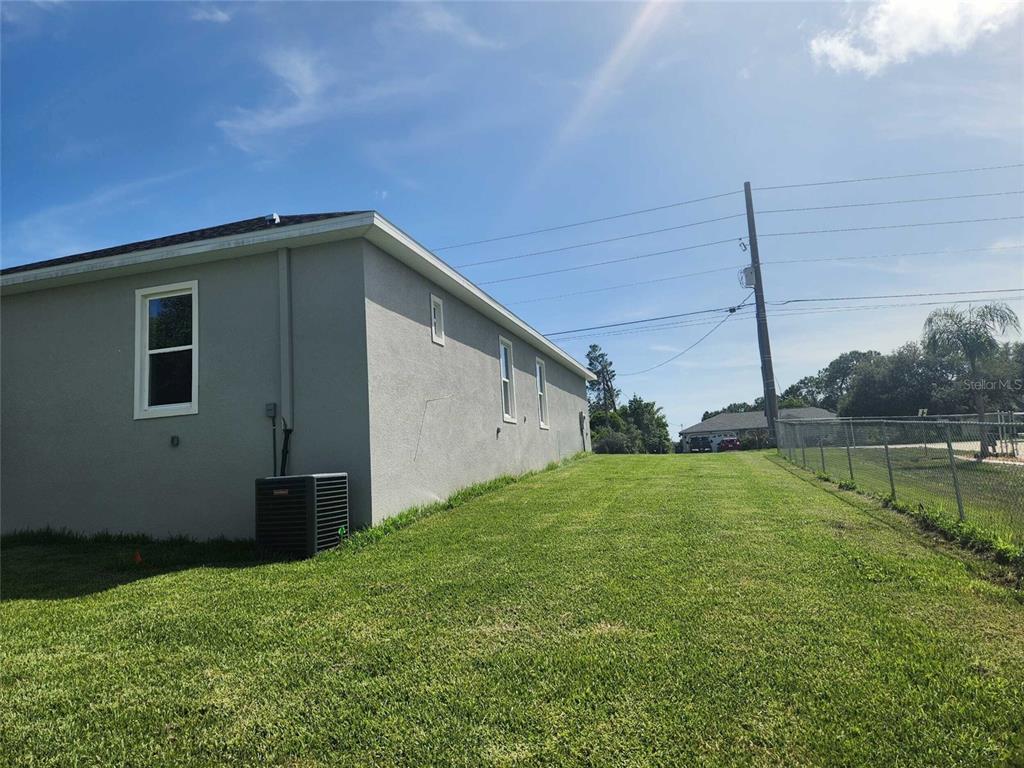 9211 Northcliffe Boulevard Spring Hill, FL 34606 - Photo 29 of 30 a backyard of a house with lots of green space