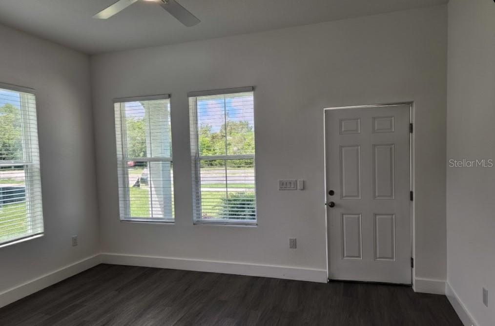 9211 Northcliffe Boulevard Spring Hill, FL 34606 - Photo 4 of 30 a view of an empty room with wooden floor and a window