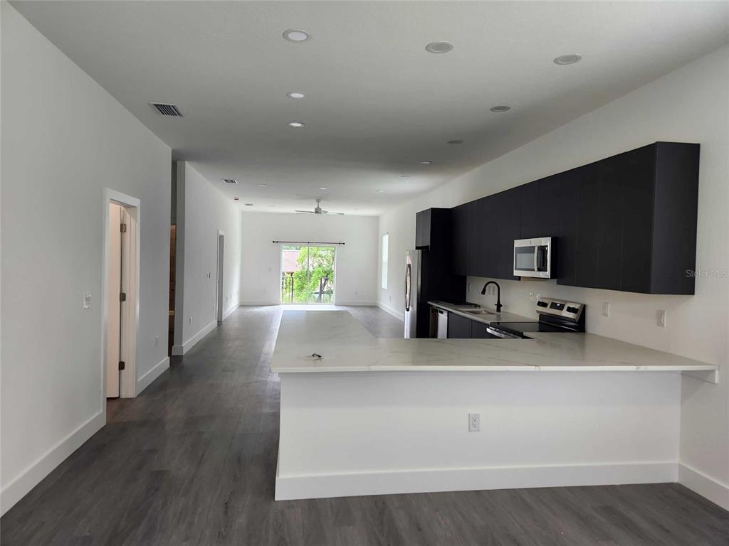 9211 Northcliffe Boulevard Spring Hill, FL 34606 - Photo 7 of 30 a view of living room with furniture and flat screen tv