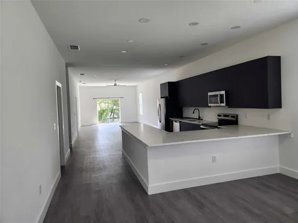 a kitchen with a refrigerator and a sink