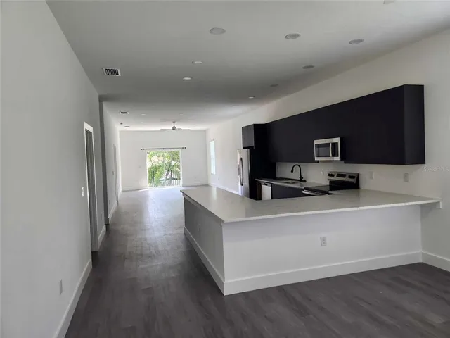 a kitchen with a refrigerator and a sink