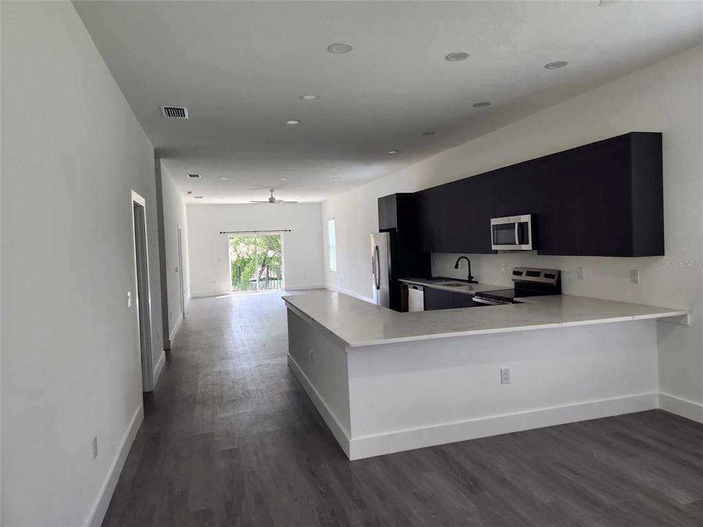 9211 Northcliffe Boulevard Spring Hill, FL 34606 - Photo 8 of 30 a living room with furniture and a flat screen tv