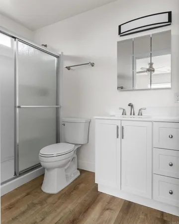 a bathroom with a toilet and a mirror