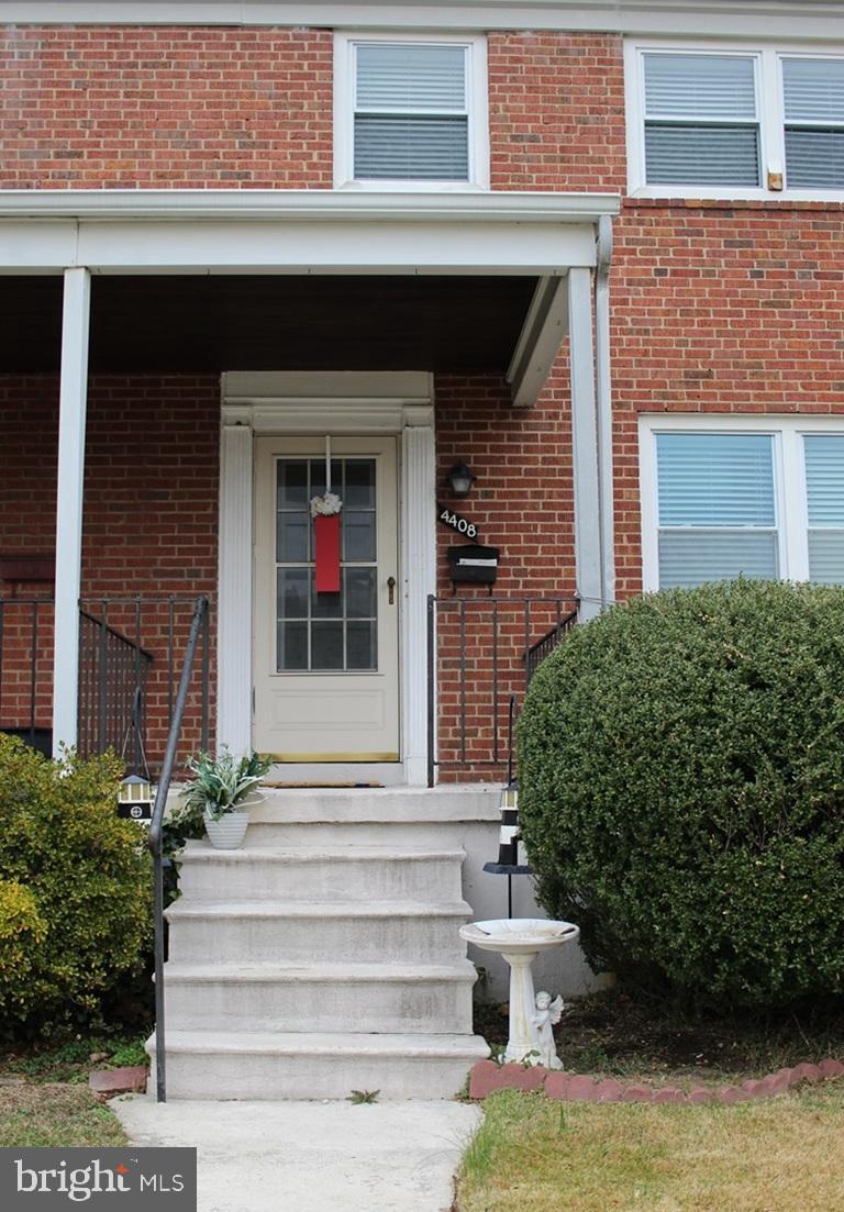 a front view of a house with potted plants