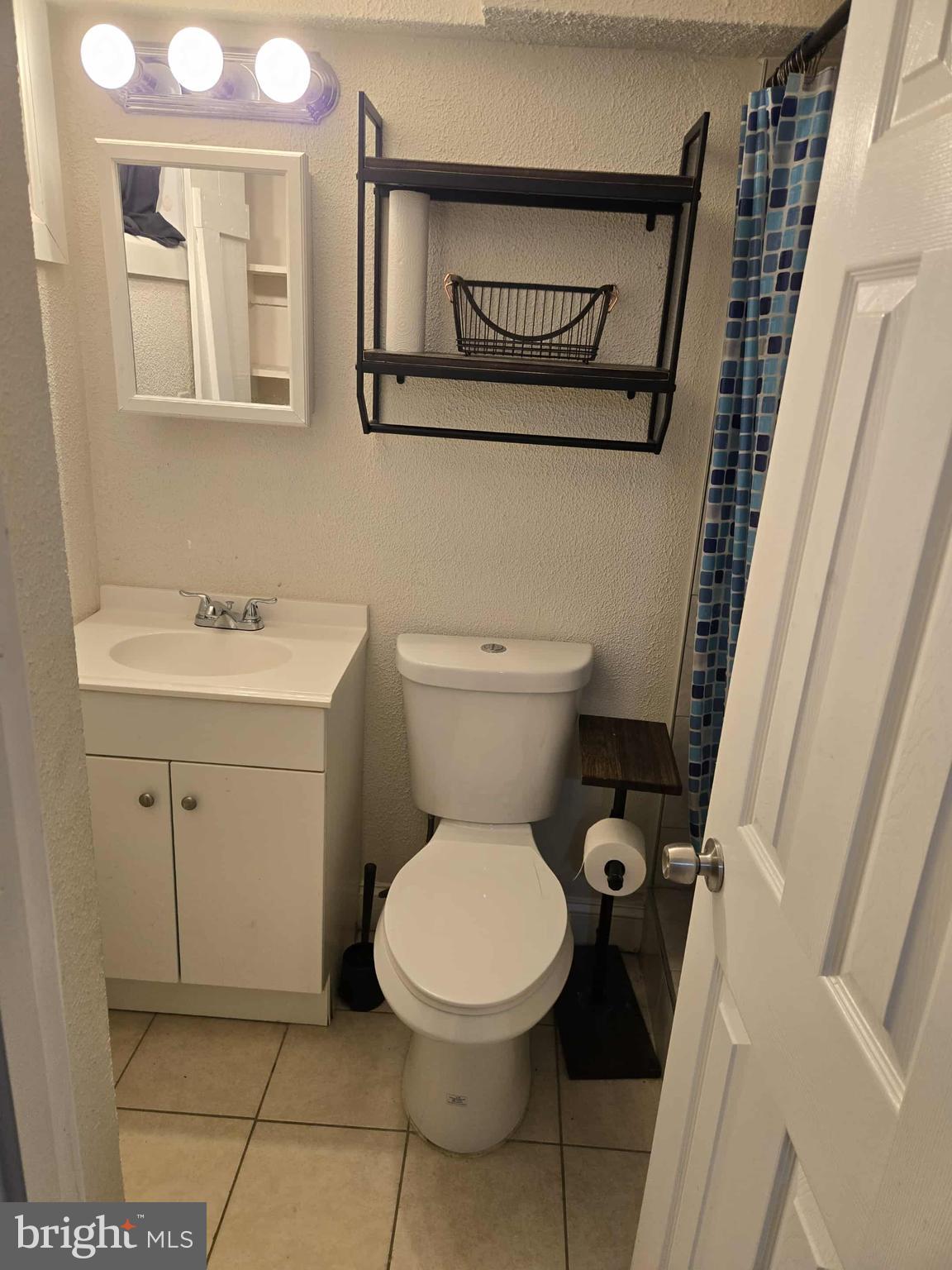 4408 Shamrock Avenue Baltimore, MD 21206 - Photo 13 of 18 a bathroom with a toilet sink and mirror