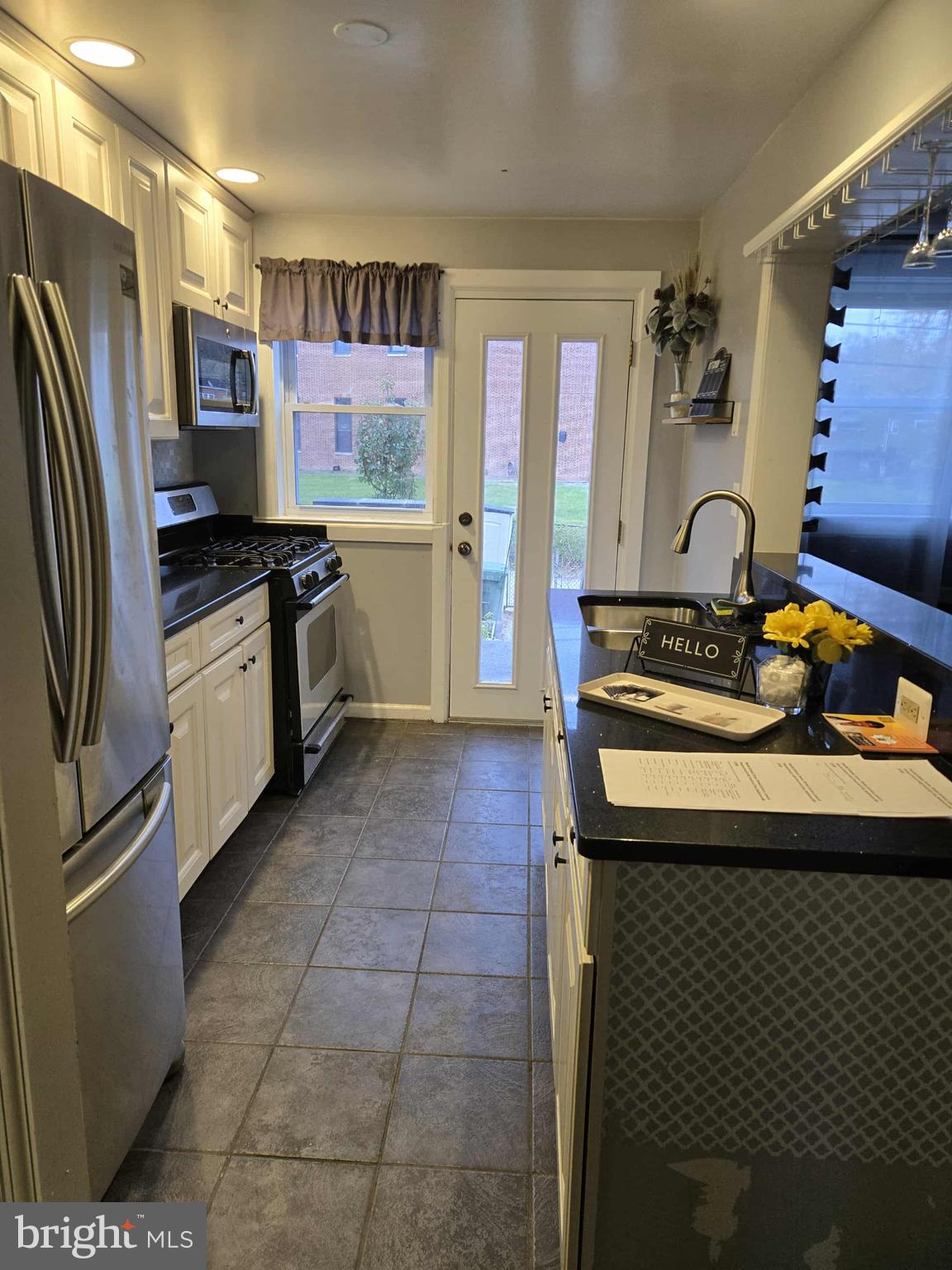 4408 Shamrock Avenue Baltimore, MD 21206 - Photo 4 of 18 a kitchen with stainless steel appliances granite countertop a refrigerator and a stove