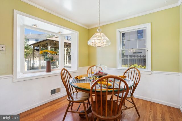 a dining room with furniture a livingroom and wooden floor