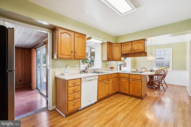 a kitchen with wooden floors and wooden cabinets