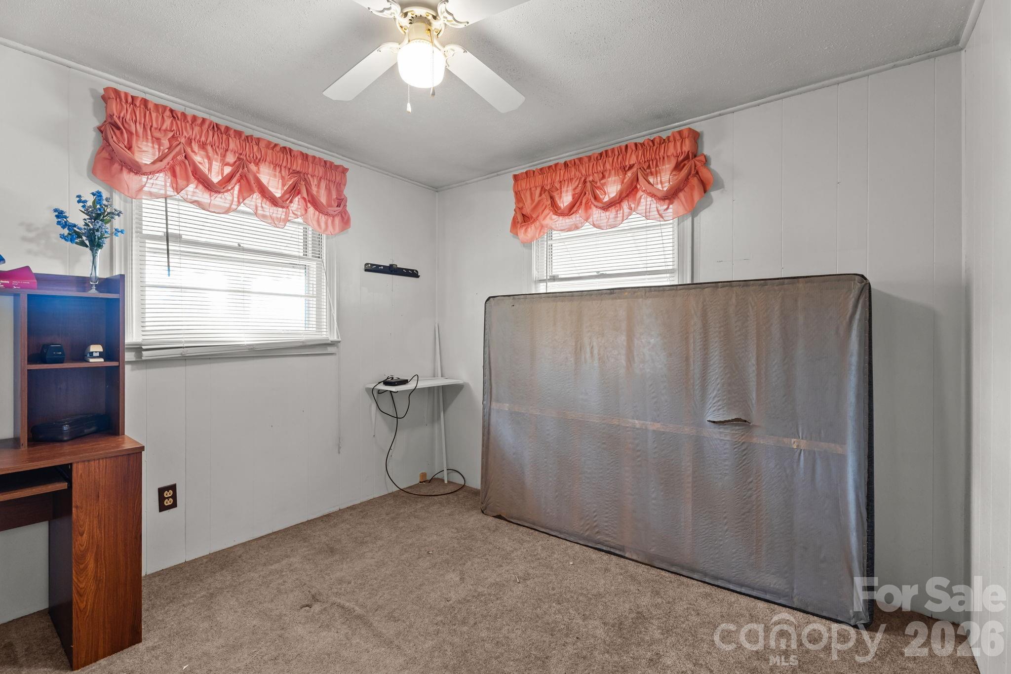407 Conwell Road Pleasant Hill, NC 27866 - Photo 13 of 31 an empty room with windows and fan