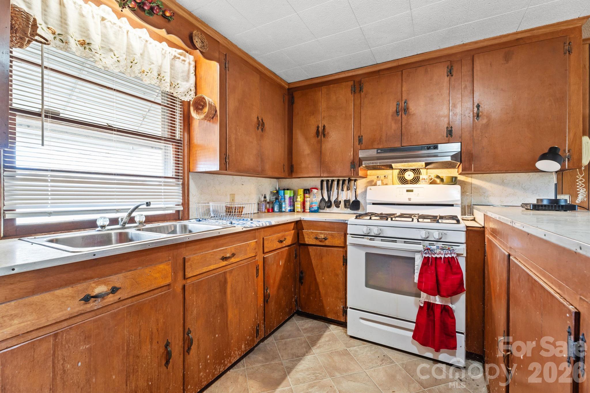 407 Conwell Road Pleasant Hill, NC 27866 - Photo 3 of 31 a kitchen with stainless steel appliances granite countertop a sink stove and refrigerator