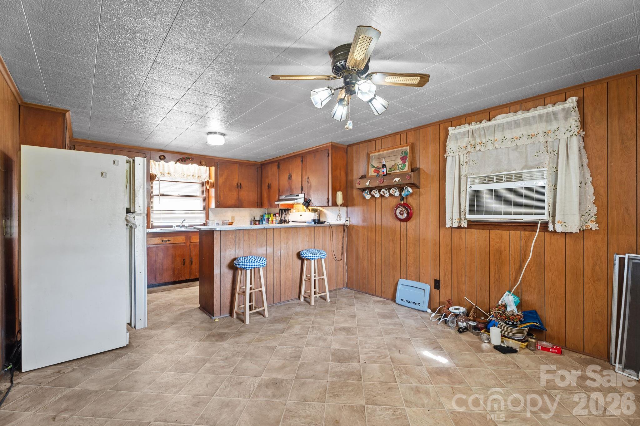 407 Conwell Road Pleasant Hill, NC 27866 - Photo 5 of 31 a view of a kitchen with furniture and a ceiling fan