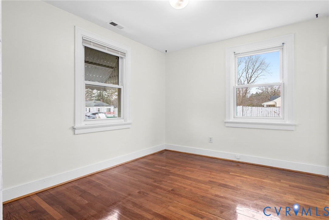 609 Woodstock Road Richmond, VA 23224 - Photo 21 of 33 a view of an empty room with wooden floor and a window