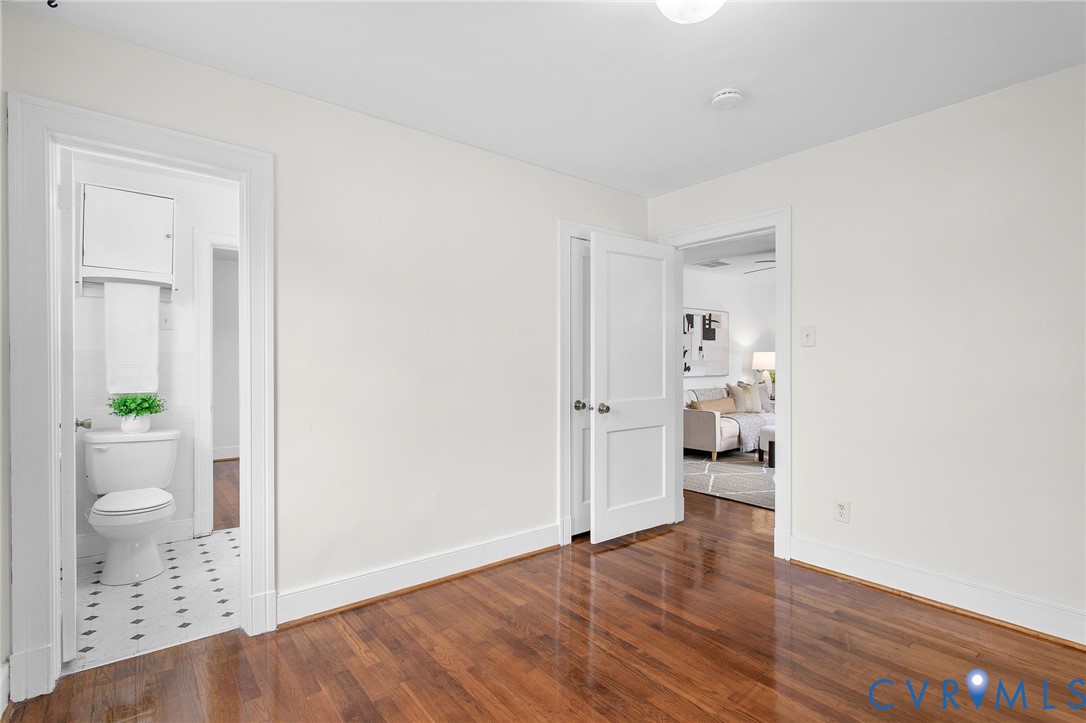 609 Woodstock Road Richmond, VA 23224 - Photo 22 of 33 wooden floor in an empty room and a bathroom