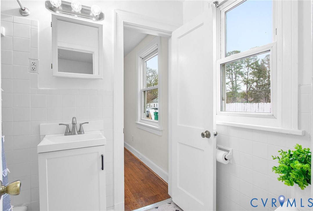 609 Woodstock Road Richmond, VA 23224 - Photo 23 of 33 a bathroom with a sink vanity and a mirror