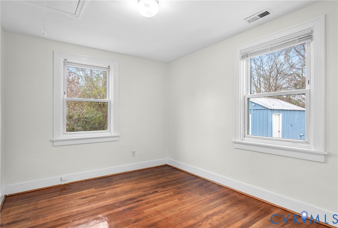 609 Woodstock Road Richmond, VA 23224 - Photo 25 of 33 a view of an empty room with wooden floor and a window