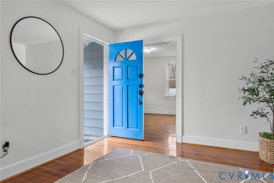 609 Woodstock Road Richmond, VA 23224 - Photo 5 of 33 a view of a room with wooden floor and a potted plant