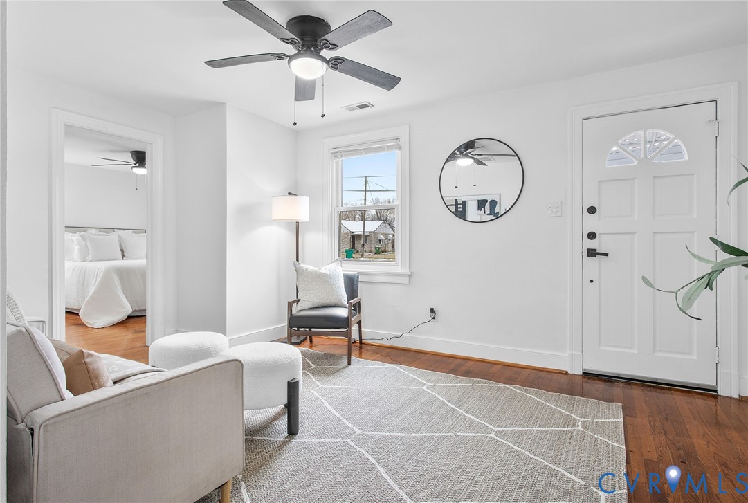 609 Woodstock Road Richmond, VA 23224 - Photo 7 of 33 a living room with furniture a window and a ceiling fan