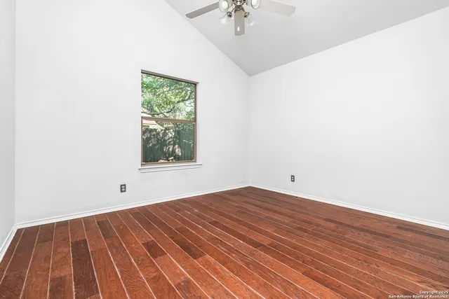 a view of room with window and hardwood floor