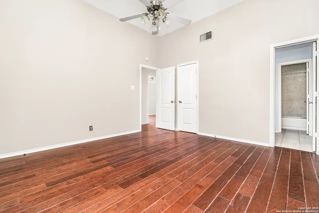 a view of a room with wooden floor and chandelier