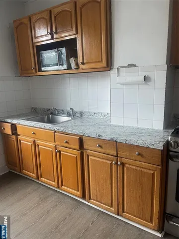 a kitchen with stainless steel appliances granite countertop a sink and a microwave