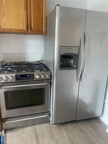 a stove top oven sitting inside of a kitchen
