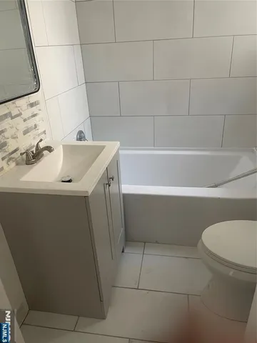 a bathroom with a sink a toilet and bathtub