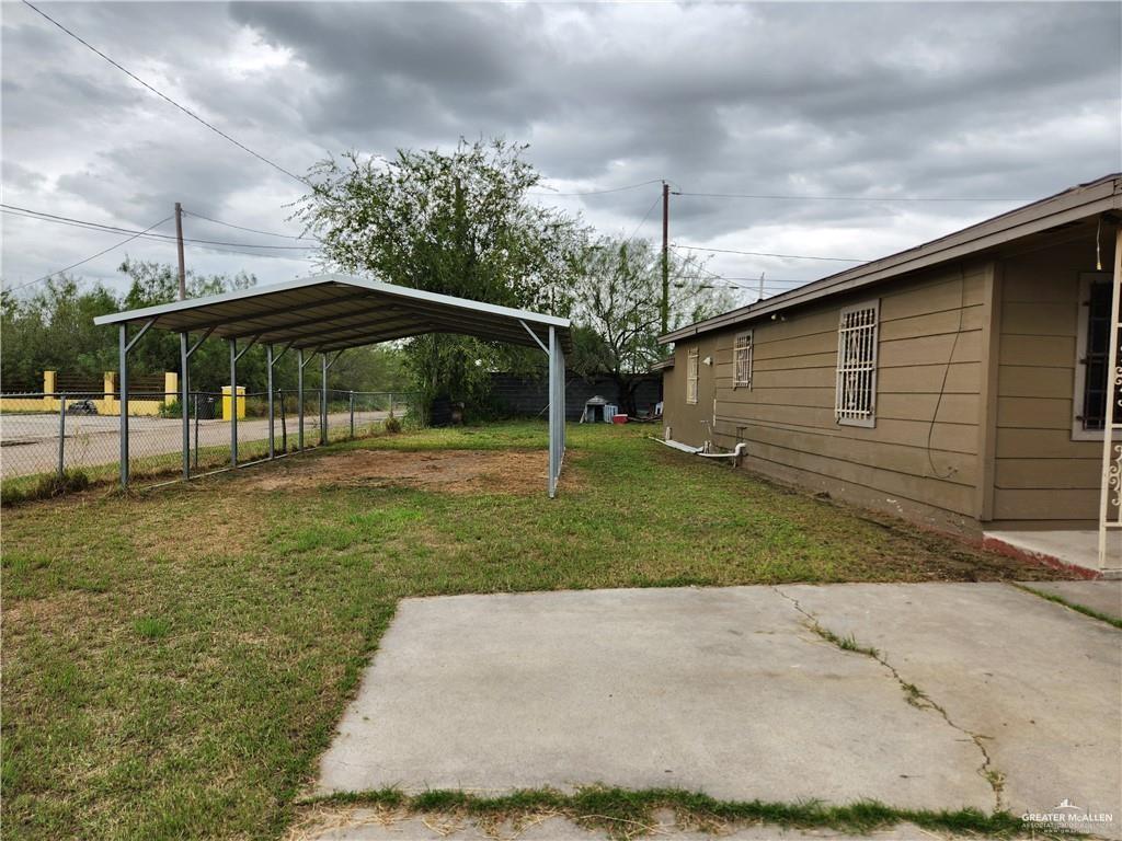 2981 Azalea Street Roma, TX 78584 - Photo 12 of 15 a view of a backyard with table and chairs under an umbrella