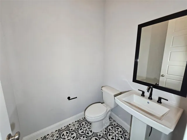 a bathroom with a sink toilet and mirror