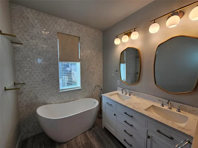 a bathroom with a double vanity sink and a mirror