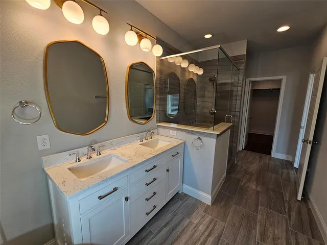 a bathroom with a granite countertop sink mirror and vanity
