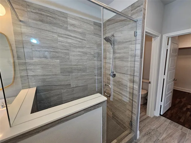 a bathroom with a shower and toilet