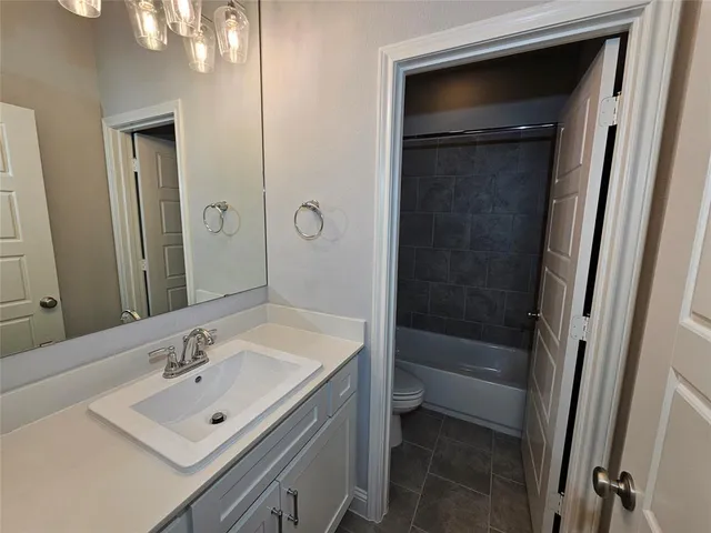 a bathroom with a sink a shower and a mirror