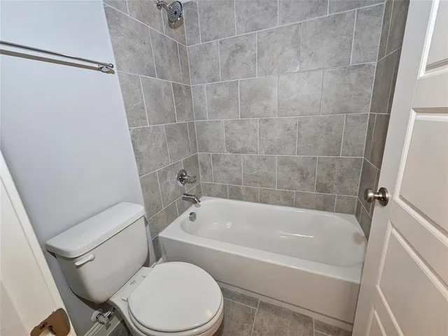 a white bath tub sitting next to a white toilet