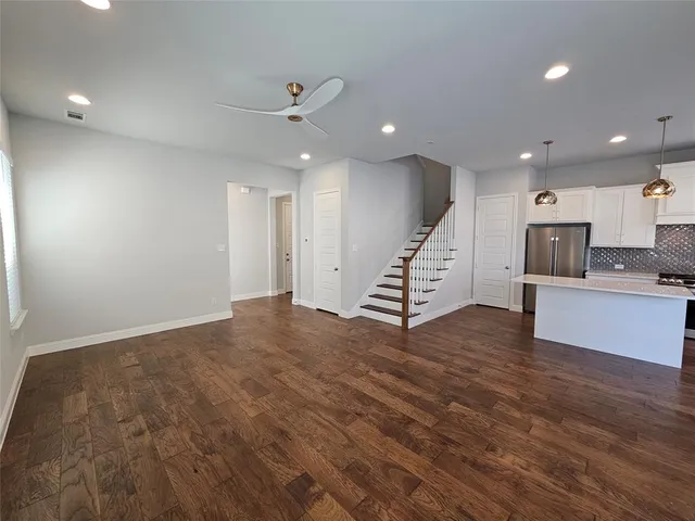 a view of kitchen and hall with wooden floor