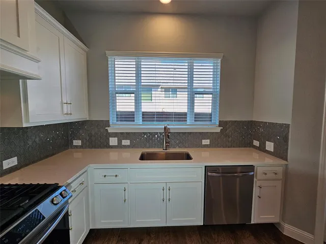 a kitchen with a sink and cabinets