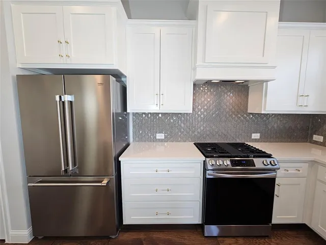 a kitchen with appliances and cabinets