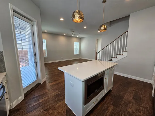 a kitchen with wooden floor and window